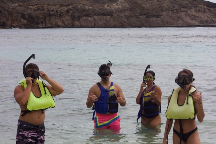 a group of people on a beach near a body of water