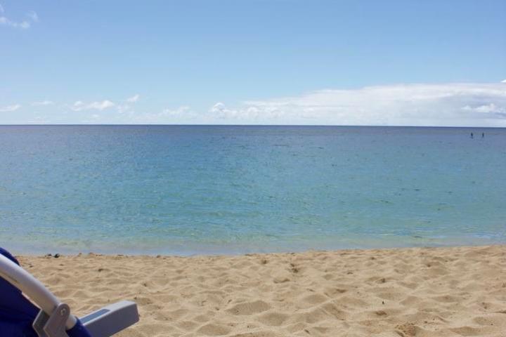 a chair sitting in front of a beach